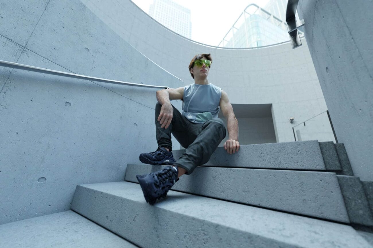 Urban modern architecture with a male model in stylish athletic wear, showcasing contemporary design elements, concrete textures, and city backdrop. Perfect for fashion, lifestyle, and architectural visuals.