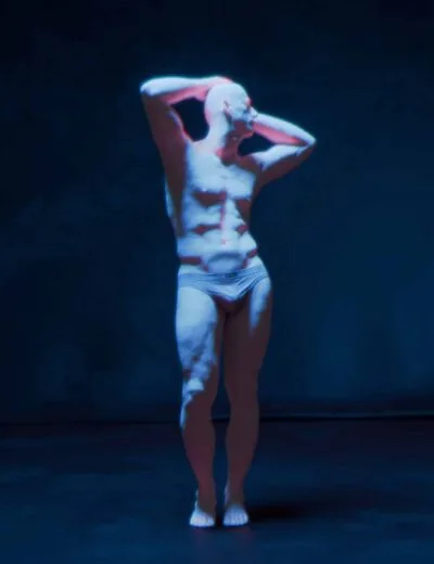 3D human male model with a muscular build, standing on a dark stage, illuminated by colorful stage lighting, showcasing realistic anatomy and posing for 3D art and animation projects.