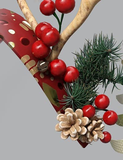 Festive reindeer antler headband with berries, pinecones, greenery, perfect for holiday celebrations.