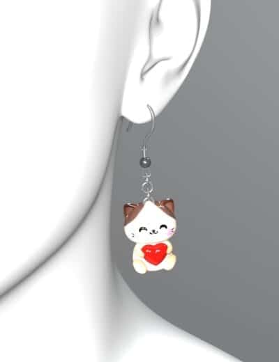 Cute cartoon cat dangle earring with red heart charm, playful jewelry for pet lovers.