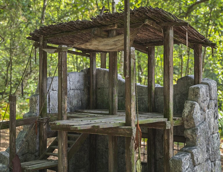 Old rustic wooden lookout amid lush forest, blending natural materials and weathered wood, evoking solitude.