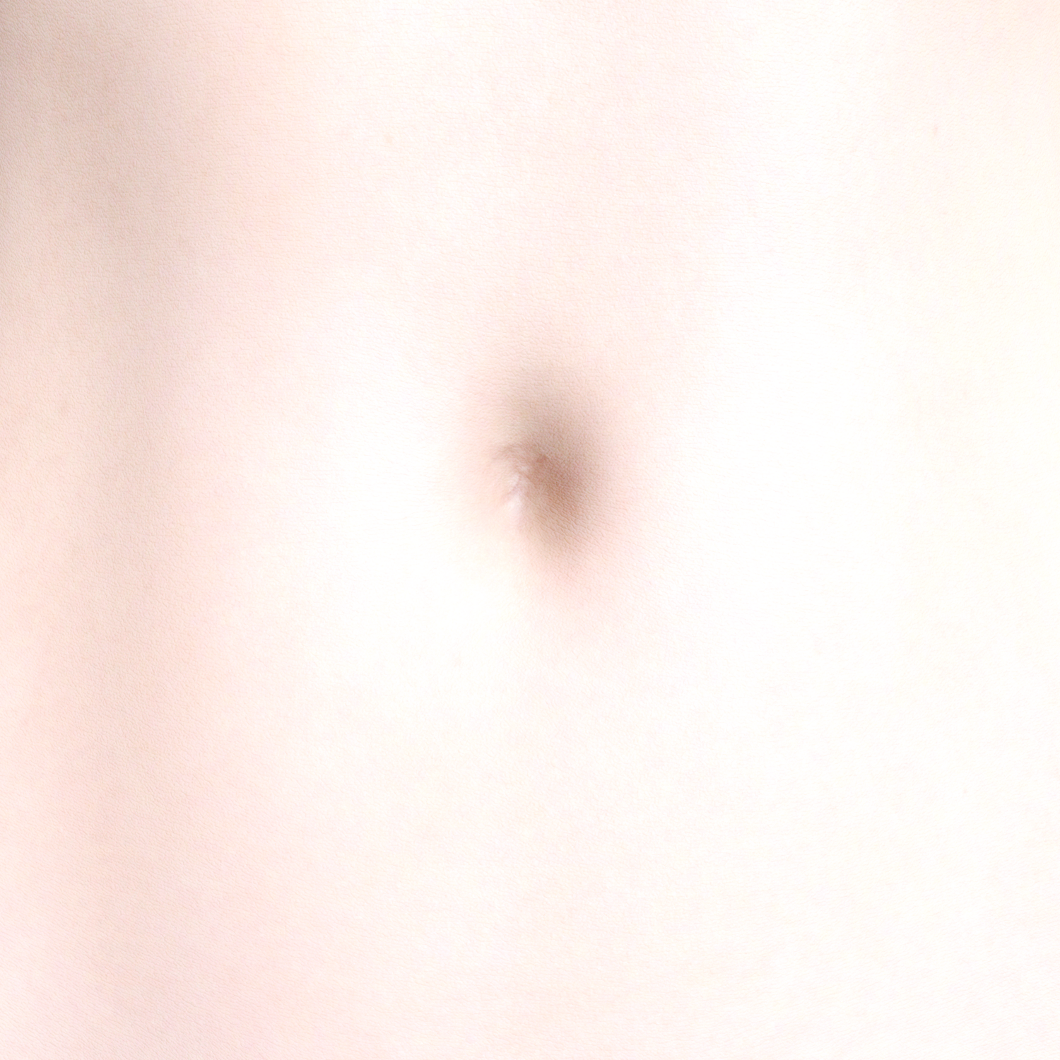 Close-up of a smooth, light skin abdomen with a gently indented navel and minimalist aesthetic.