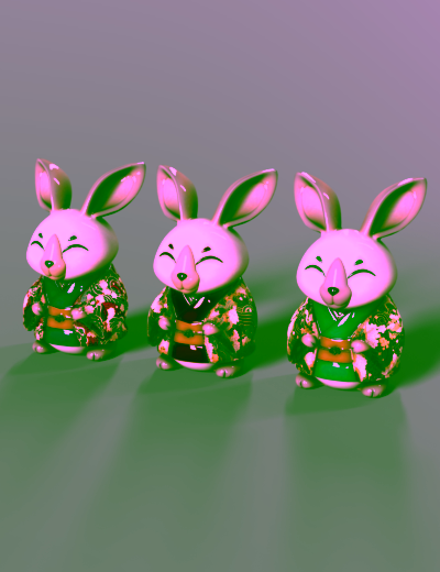 Three colorful ceramic rabbit figurines in traditional kimonos with joyful expressions and intricate detailing.