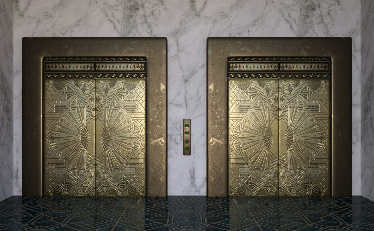 Elegant Art Deco elevator doors with geometric designs in a luxurious marble and polished stone setting.