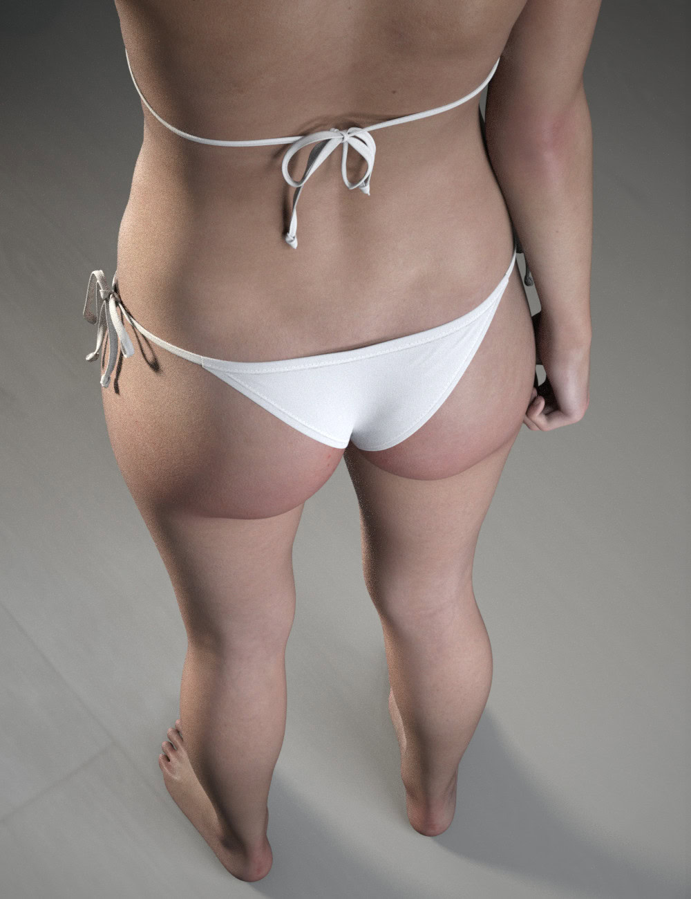 Rear view of barefoot woman in a white string bikini against a gray wall.
