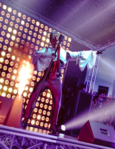 Rock singer performs onstage with flames, amber lights, and dramatic purple concert lighting.